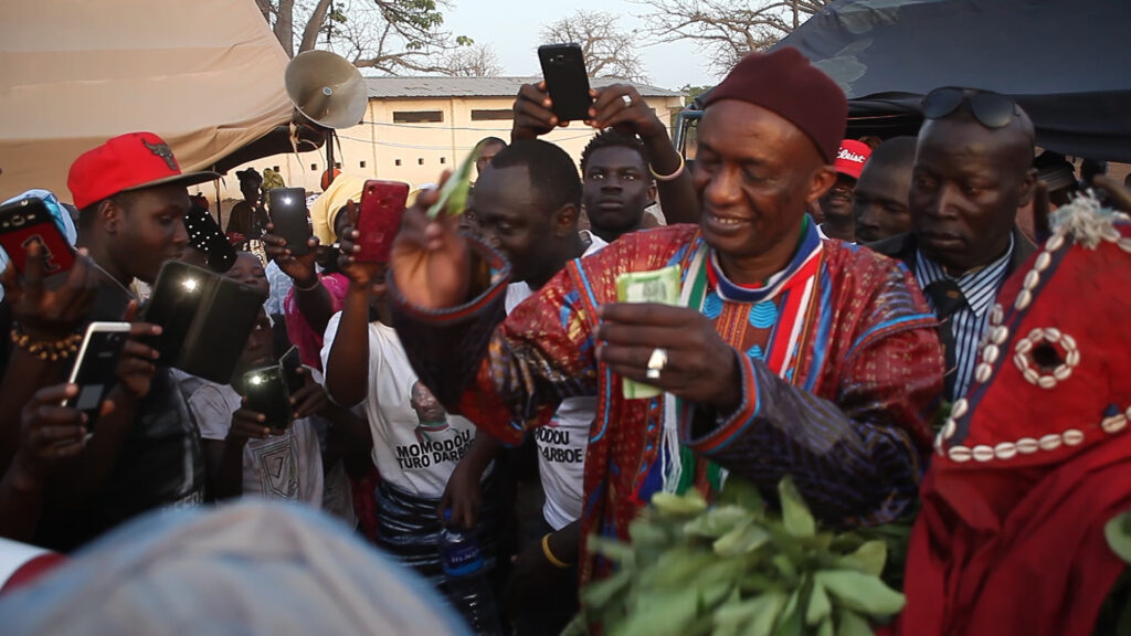 CEO showing appreciation of the local traditional display by showering performers with money