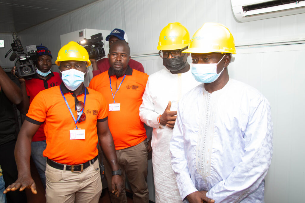 16. Unique Energy Engineer explaining to the officials how the Mini grid system operates8