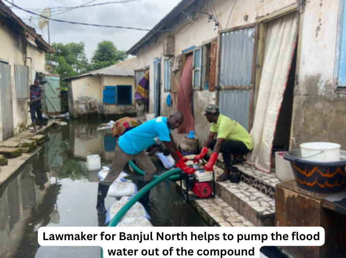 Lawmaker for Banjul North helps to pump the flood water out of the compound 3