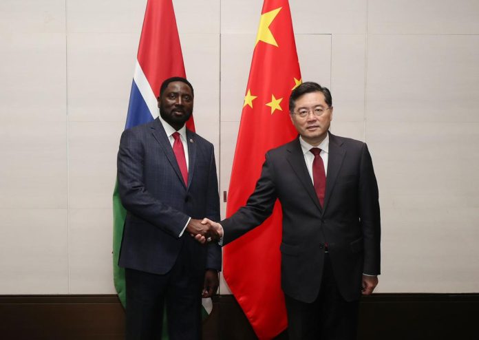 The. Gambia's Foreign Minister Mamadou Tangara and Chinese Foreign Minister Qin Gang pose after a bilateral meeting on the sidelines of the Lanting Forum held in April in Shanghai