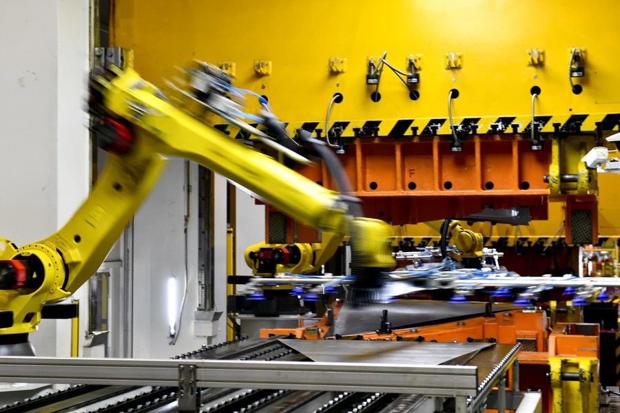 This photo taken on June 29 2023 shows an industrial robot processing auto parts at carmaker ZXAUTO in Rizhao Hi Tech Industrial Development Zone of Rizhao City east Chinas Shandong Province