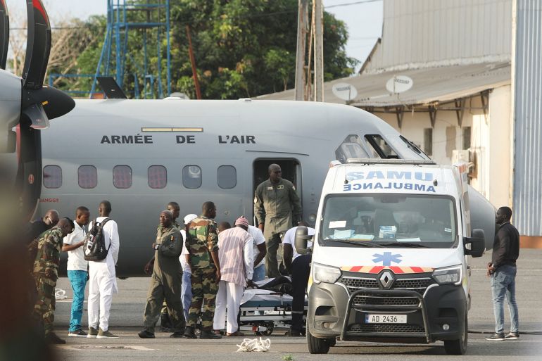 Surviving migrants from a boat lost at sea in July and found in Cape Verde with several survivors arrive on the runway at the Dakar Ouakam Air Base in Dakar Senegal on August 21 2023 Ngouda DioneReuters