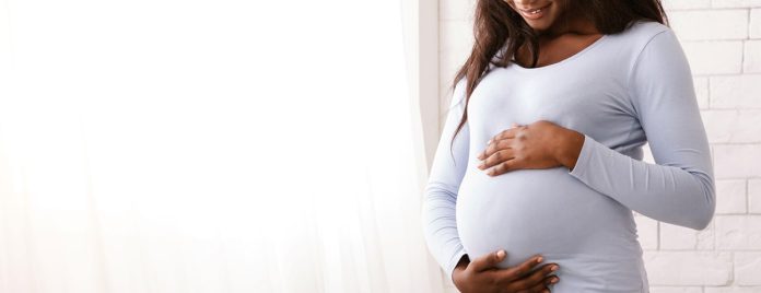 pregnantwomanholdsbellyhero